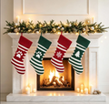 Red and green striped Christmas stockings hanging by a fireplace, including paw-print designs