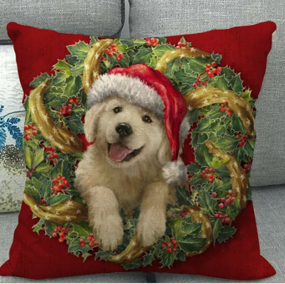 Red Christmas cushion cover featuring a golden puppy in a Santa hat framed by a holly wreath